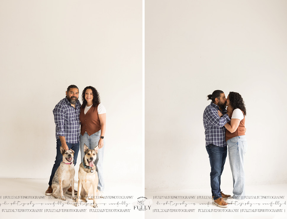 couple in a studio with their dogs enjoying a family photoshoot