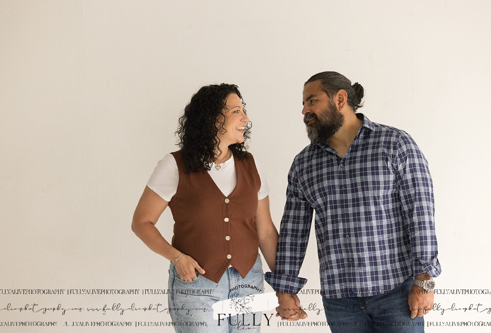 couple in a studio with their dogs enjoying a family photoshoot