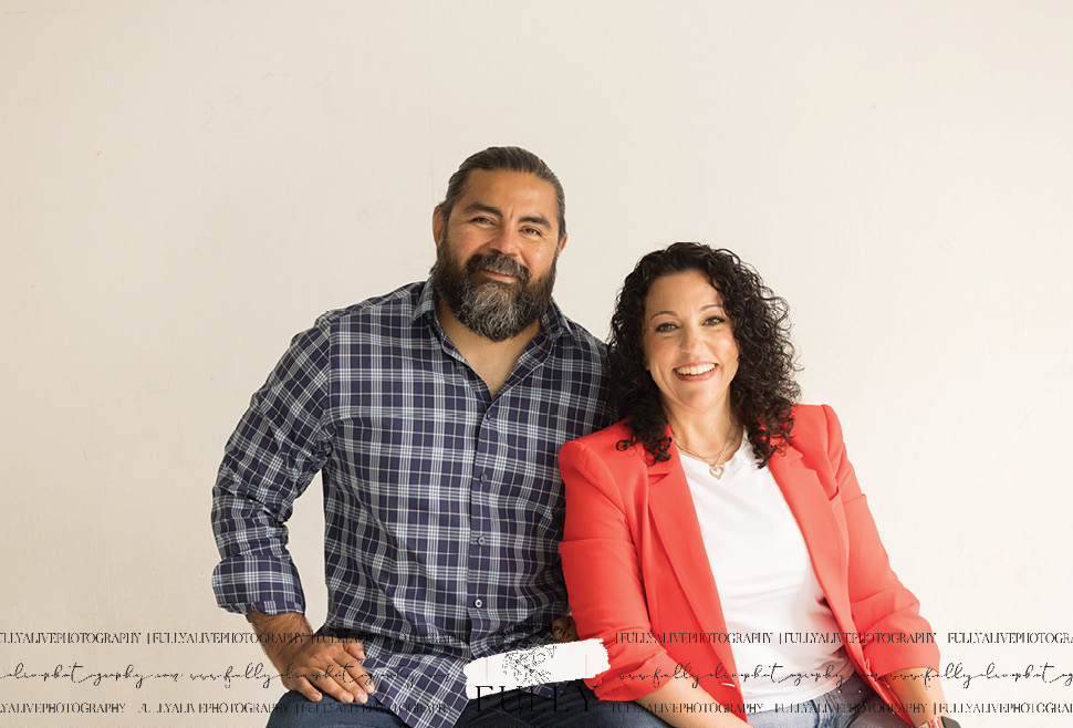 couple in a studio with their dogs enjoying a family photoshoot